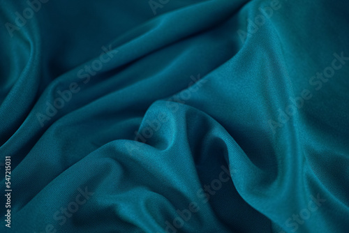 A crumpled teal fabric background