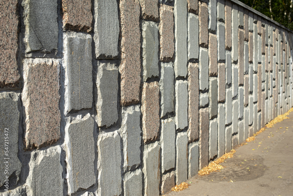 Wall of tiles. Fence made of stone. Details of building. Wall of tiles. Fence made of stone. Details of building.