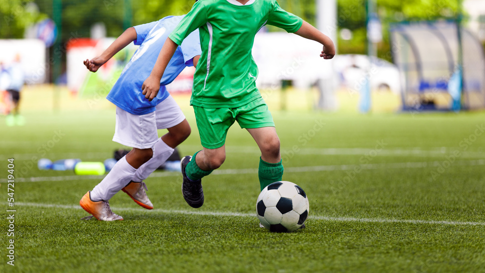 Football Soccer Match for Children. Kids Playing Soccer Tournament Game. Boys Running and Kicking Football. Soccer Stadium in the Background Football Soccer Match for Children. Kids Playing Soccer Tournament Game. Boys Running and Kicking Football. Soccer Stadium in the Background