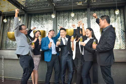 Asian people group drinking in party congratulation business team ,Group Of Friends Enjoying Evening Drinks In Bar