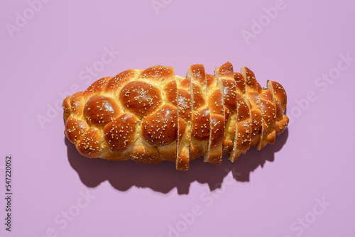 Tableau sur toile Sliced challah bread top view on a purple background