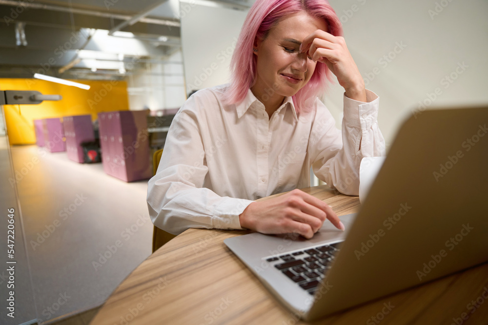 Woman getting frustrated while working in office Woman getting frustrated while working in office