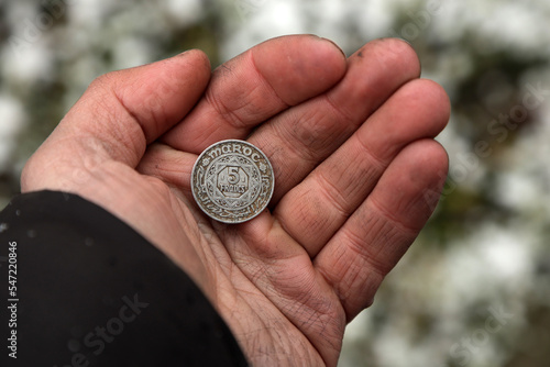 Old Moroccan coin in hand