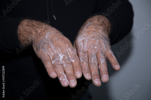 Hand of a man applying cream lotion on arms to protect