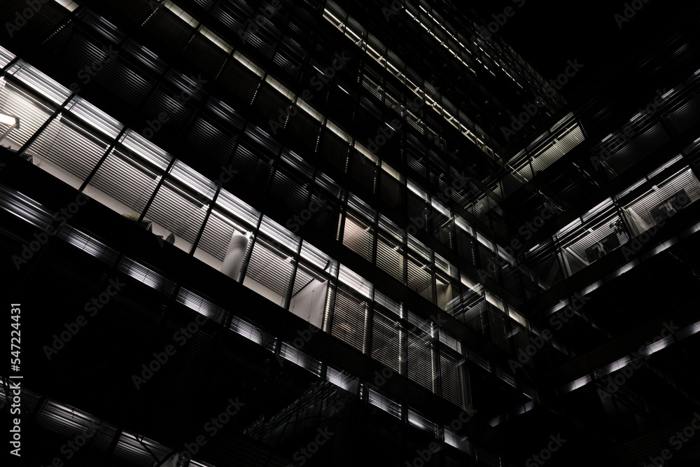 A dark night in Berlin - Berlin nighttime architecture. Modern architecture building, office building with lights in windows. A dark night in Berlin - Berlin nighttime architecture. Modern architecture building, office building with lights in windows.