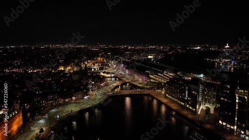 Wallpaper Mural Amsterdam city center skyline by night aerial drone overhead view. Amsterdam Centraal, Ij, Oosterdok, Prins Hendrikkade, public transport, traffic at night. Bright lights urban Torontodigital.ca