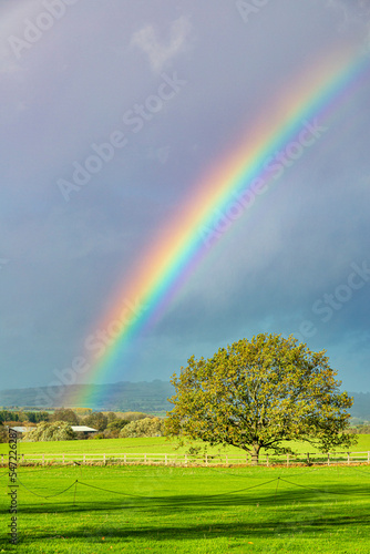 A rainbow over fields near the Cotswold village of Laverton, Gloucestershire, England UK