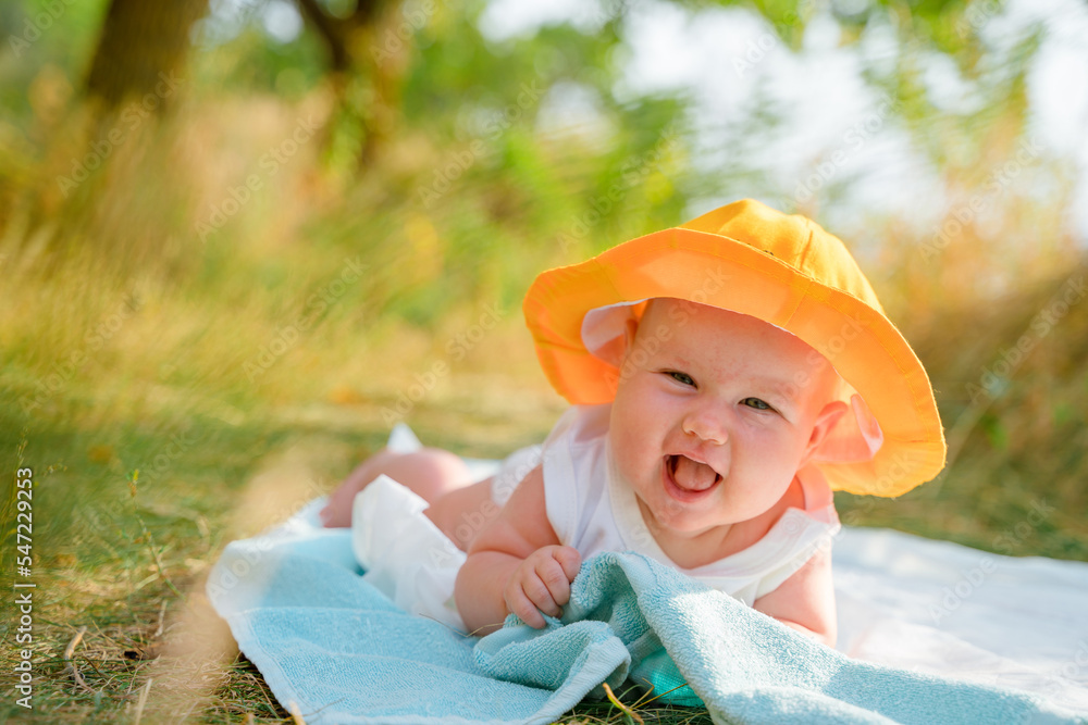 Funny baby toddler in a panama hat is relaxing on the beach outdoors in summer Stock Foto Adobe Stock