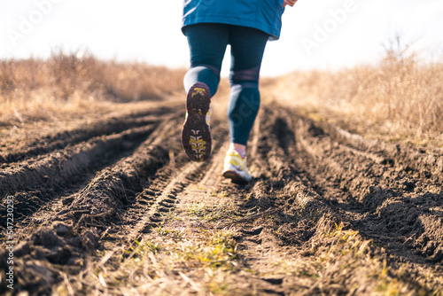 Woman feet in sneakers at the start. New start of the new year 2023, goals and plans for the next year. Starting to new year