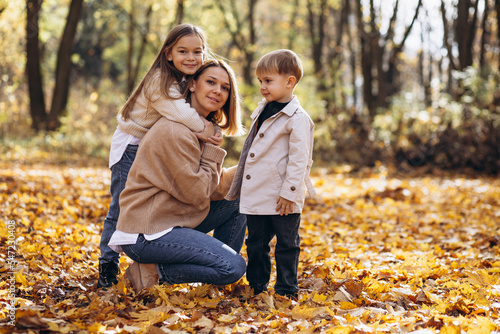 Mother with children having fun in autumn park