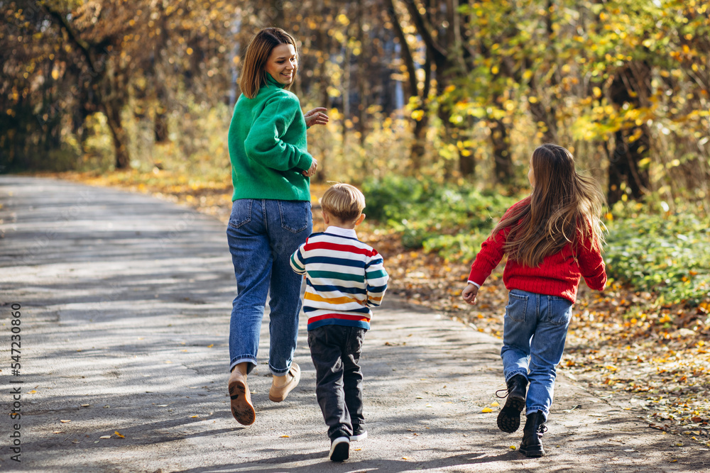 Fototapeta premium Mother with children walking in park