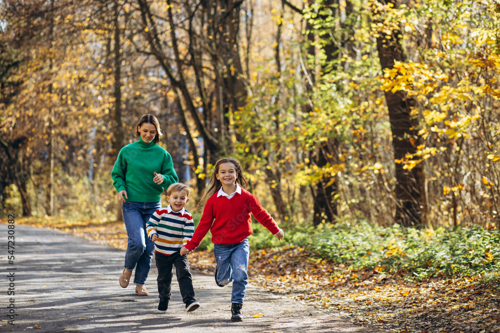 Fototapeta premium Mother with children walking in park