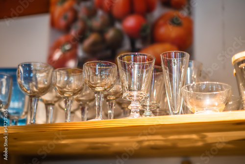 Empty glasses on a wooden shelf