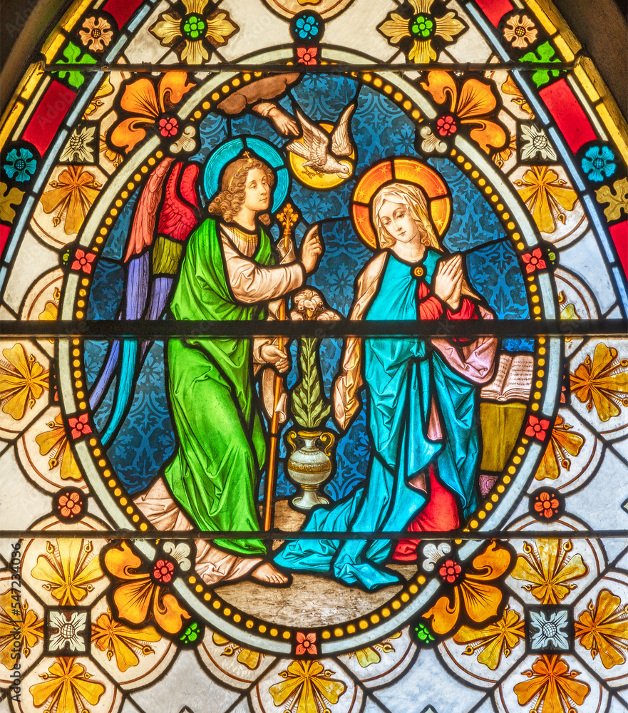 BIELLA, ITALY - JULY 15, 2022: The Annunciation in the stained glass of Duomo from 19. cent.
