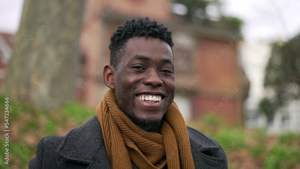 Happy black African man looking at camera smiling portrait during winter season3 Happy black African man looking at camera smiling portrait during winter season3