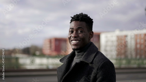 Handsome black man walks in slow-motion outdoors in street