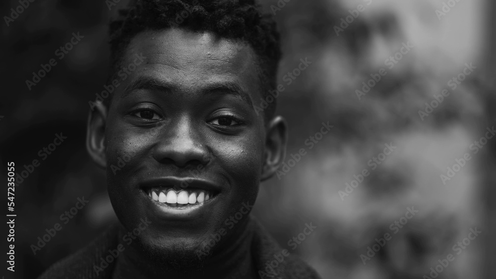 Happy African man smiling at camera, black and white monochrome Happy African man smiling at camera, black and white monochrome