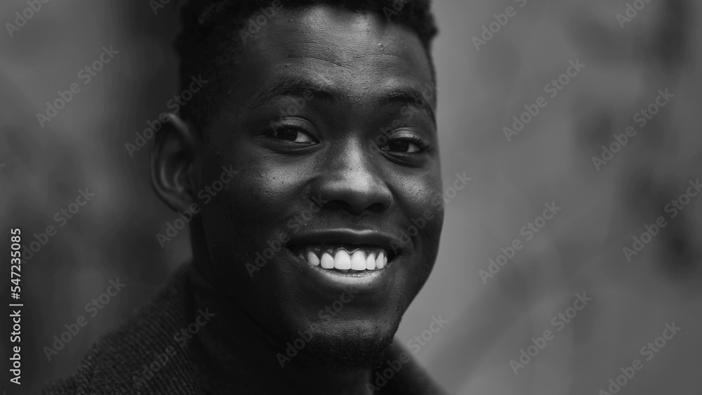 Happy African man smiling at camera, black and white monochrome Happy African man smiling at camera, black and white monochrome