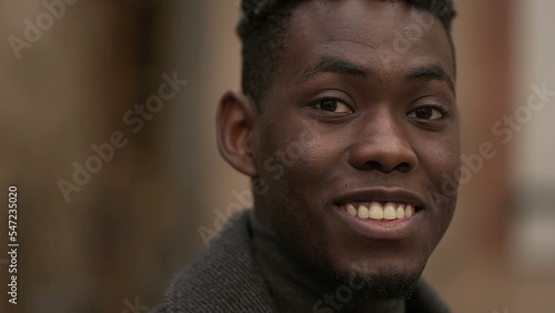 Friendly young black man smiling at camera. Charismatic handsome African person