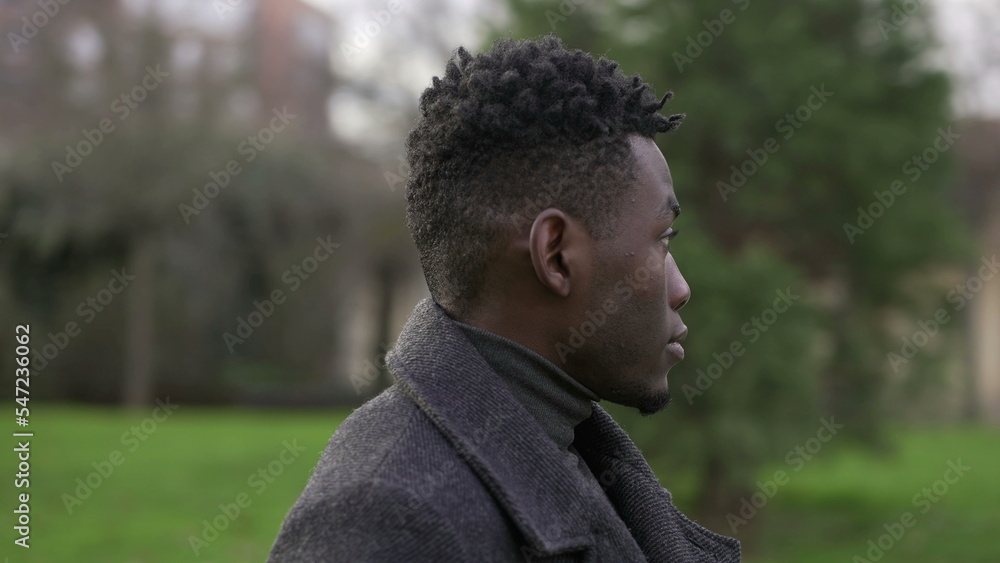 Elegant Young black man portrait standing outside at park Elegant Young black man portrait standing outside at park