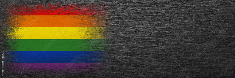 Flag of LGBT. Flag is painted on black slate stone. Stone background. Copy space. Textured background