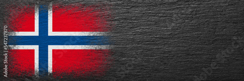 Flag of Norway. Flag is painted on black slate stone. Stone background. Copy space. Textured background