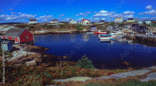 Fishing boat moorage and colorful homes at Peggys Cove Nova Scotia.  Peggys Cove is a small rural community located on the eastern shore of St. Margarets