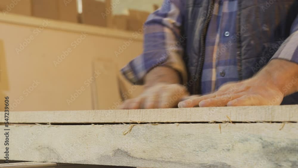 Carpenter man clapping and cleaning his dusty and sawdust hands