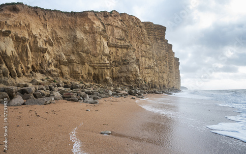 Rock formations, sandstone cliffs in West Bay beach, located near Bridport in Dorset, United Kingdom. Part of famous Jurassic coast, World Heritage Site, selective focus photo