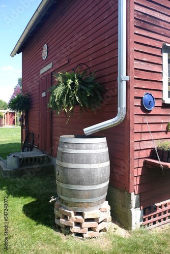 old wooden rain barrel on a farm