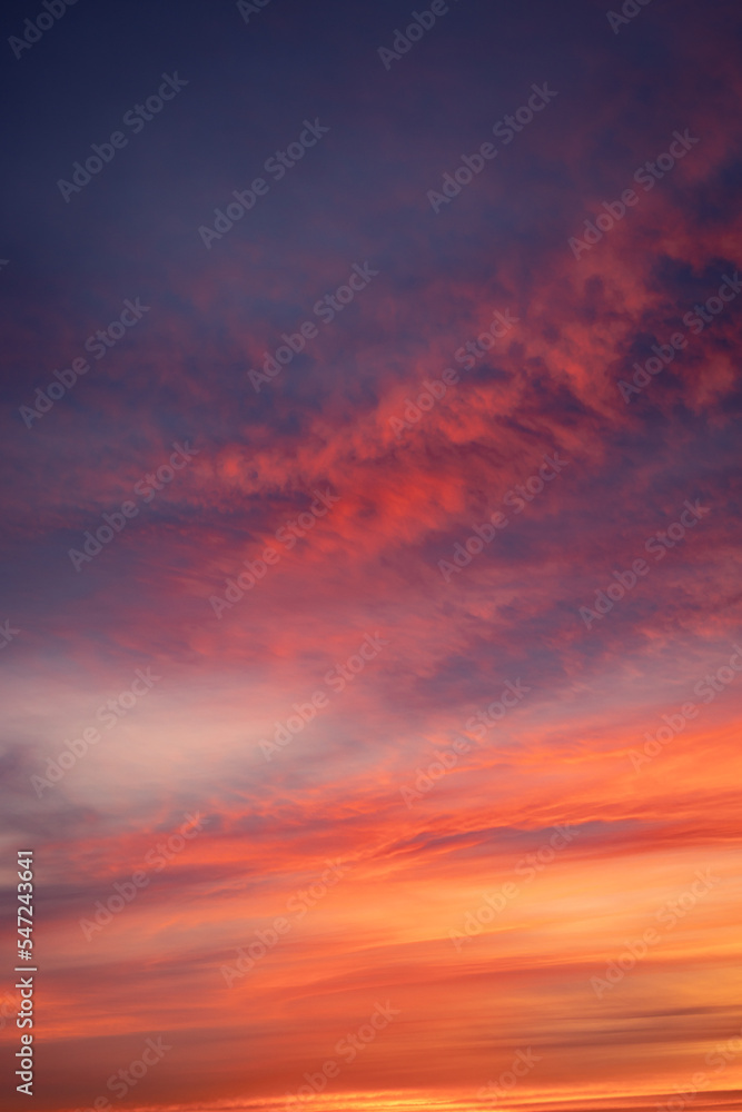 Red clouds on a dramatic colorful cold winter sunset sky, warm tones, Germany, Europe