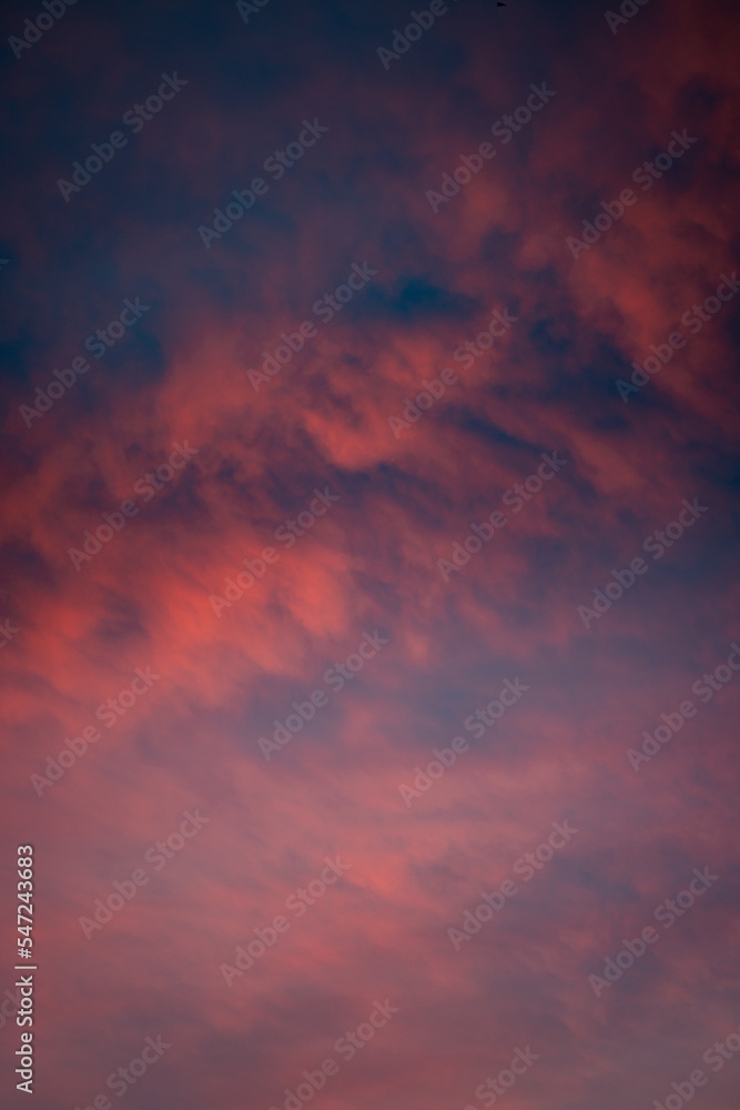 Red clouds on a dramatic colorful cold winter sunset sky, warm tones, Germany, Europe