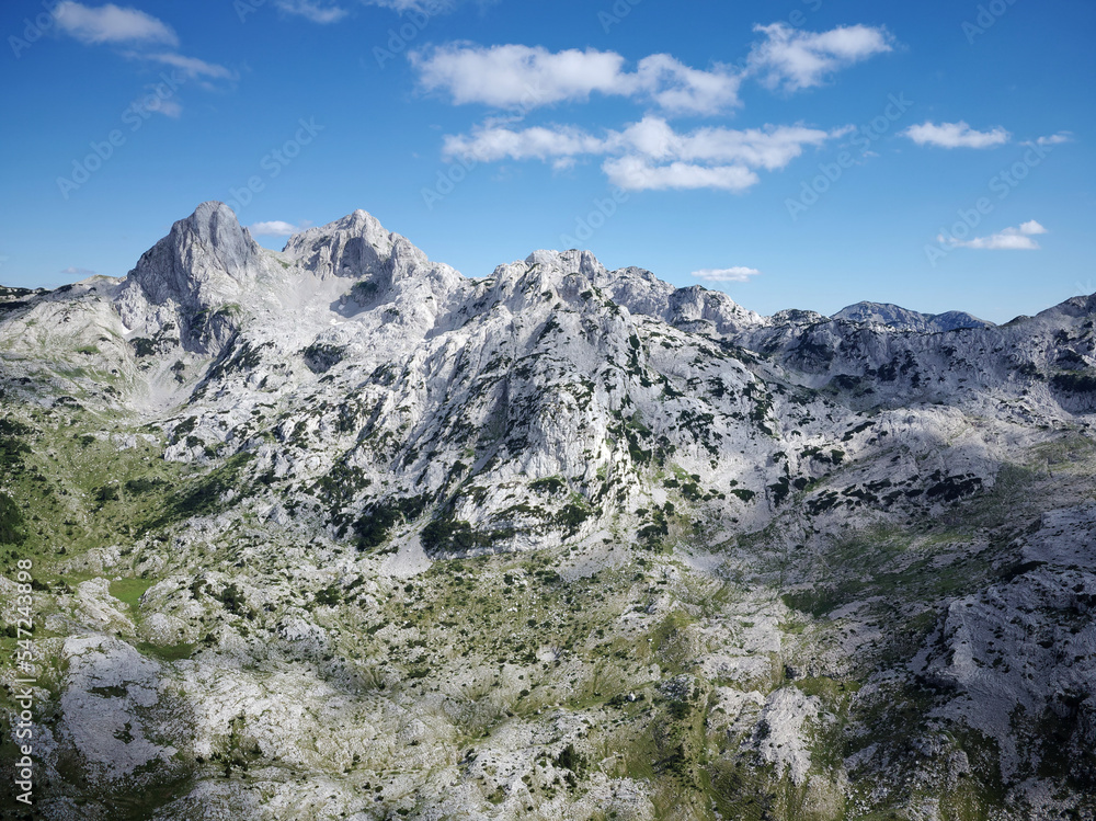 Aerial drone view of different mountain peaks during a beautiful sunny day with a green valley below. Connection with nature, More adventure in life. Prenj Mountain in Bosnia and Herzegovina. 
