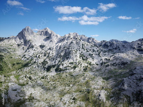 Aerial drone view of different mountain peaks during a beautiful sunny day with a green valley below. Connection with nature  More adventure in life. Prenj Mountain in Bosnia and Herzegovina.  
