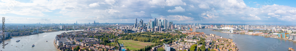 Fototapeta premium London panorama, the city on the river bank, with residential buildings, green areas, and modern skyscrapers, aerial view.