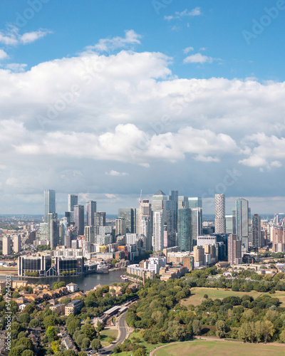 London, the city on the river bank, with residential buildings, green areas, and modern skyscrapers, aerial view.