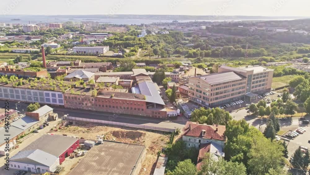 Ruined production complex with abandoned workshop buildings in city district aerial view. Urban panorama in summer Ruined production complex with abandoned workshop buildings in city district aerial view. Urban panorama in summer