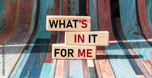 WHAT'S IN IT FOR ME text on wooden blocks and vintage background photo