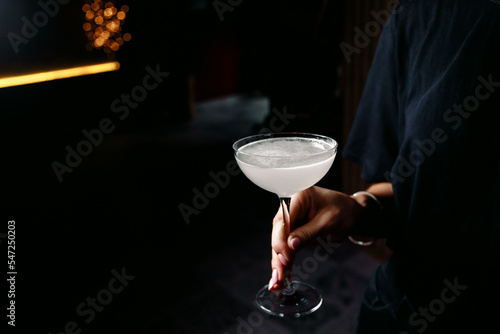 person holding a glass of alcohol cocktail