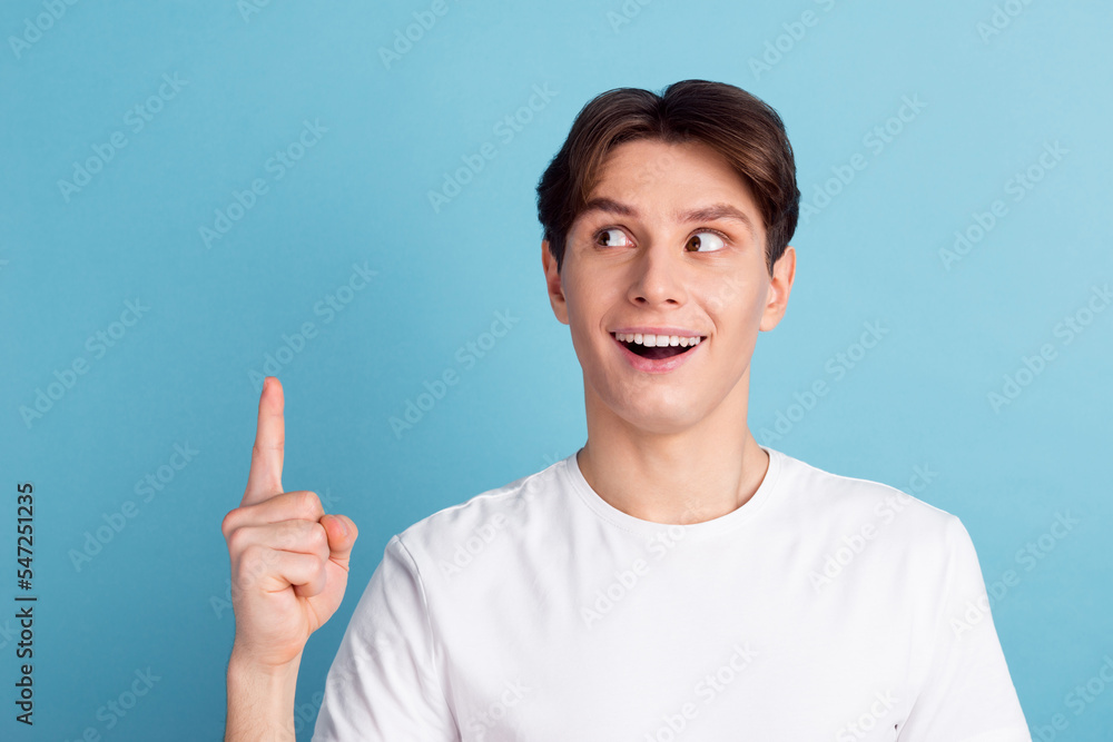 Have you seen this? Handsome young man pointing away looking incredible decision while standing against blue background Have you seen this? Handsome young man pointing away looking incredible decision while standing against blue background