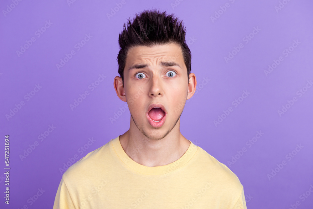 Photo portrait of shocked young man staring amazed got trouble isolated bright lilac color background Photo portrait of shocked young man staring amazed got trouble isolated bright lilac color background
