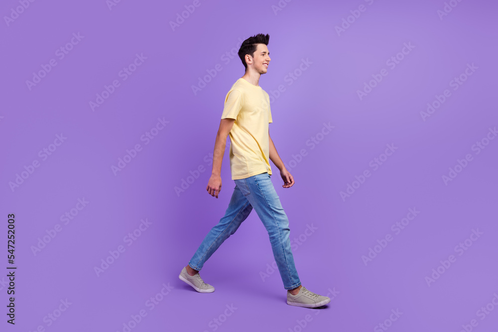 Full size photo of positive cheerful man have free time go walk wear casual style clothes isolated vivid color background Full size photo of positive cheerful man have free time go walk wear casual style clothes isolated vivid color background