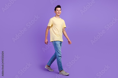 Full size photo of positive millennial man have free time walk wear casual style clothes isolated vivid color background