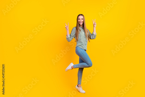 Full body photo of excited lady have fun say hello make v sign isolated over vivid shine color background
