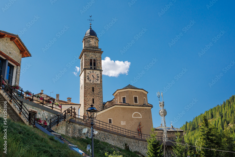 View of the Stone Bell Tower of the Church of Cogne in Aosta - Italy View of the Stone Bell Tower of the Church of Cogne in Aosta - Italy