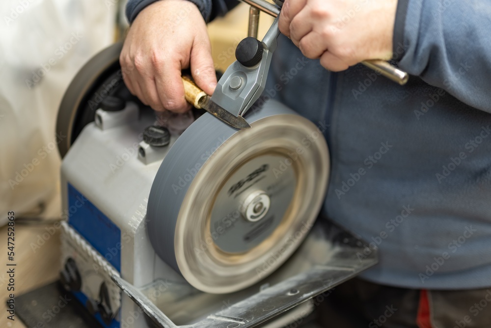 Sharpening knife process, Grindstone closeup. Electric knife