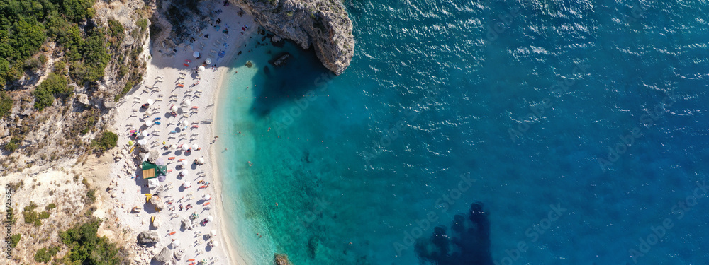Aerial drone ultra wide panoramic photo of tropical Caribbean island bay with white sand beach and beautiful turquoise and sapphire clear sea forming a blue lagoon