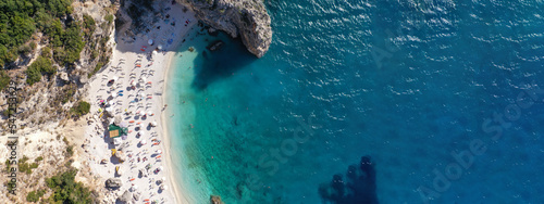 Aerial drone ultra wide panoramic photo of tropical Caribbean island bay with white sand beach and beautiful turquoise and sapphire clear sea forming a blue lagoon