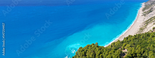 Aerial drone ultra wide panoramic photo of tropical Caribbean island bay with white sand beach and beautiful turquoise and sapphire clear sea forming a blue lagoon