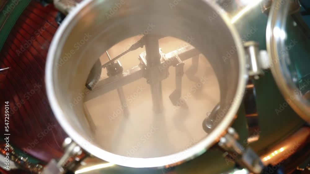 Beer is brewed in a large brewery vat. The production process of a real lager. Beer is brewed in a large brewery vat. The production process of a real lager.
